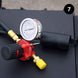 Pressure gauge and hose attachment on a black surface