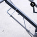 Metal spring attached to a mechanical component on a light gray background